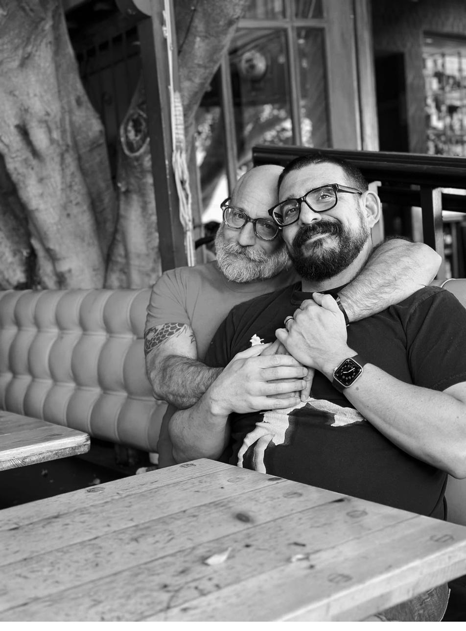 Barclay Barrios seated at a restaurant table with a friend.
